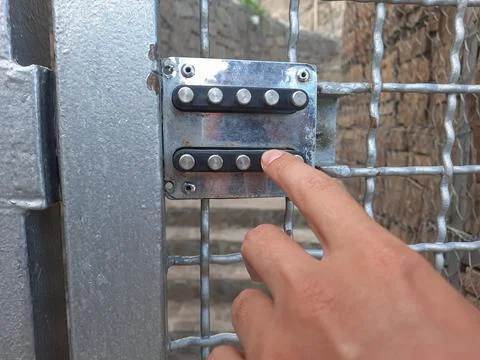 A person dials a code on a digital lock. Breaking the combination lock. Metal Stock Photos
