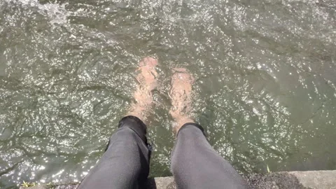 A Person Dips Their Legs into The Cold River Water Stock Footage 319306609