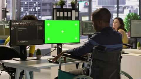 Person with disability in wheelchair checking code on mockup PC Stock Footage 318233918