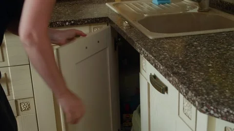 Person discarding trash into kitchen waste bin 動画素材 344516722