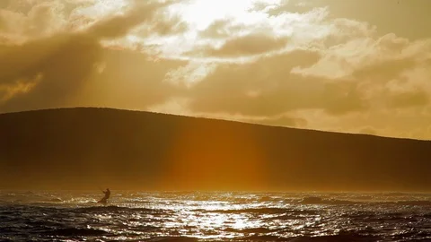 Person in the distance kiteboarding over waves. Stock Footage 88342353