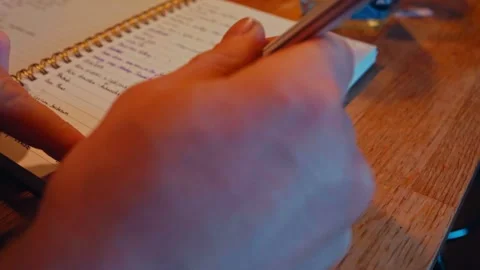 A Person Documents the Seed Germination Process in a Notebook - Close Up Stock Footage 304030297