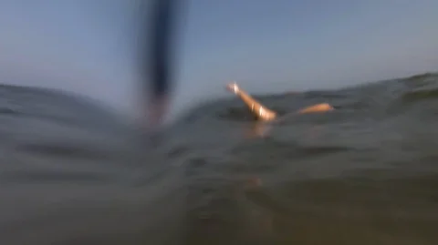 Person does acrobatic Handstand underwater in shallow ocean for sport Stock Footage 130116740