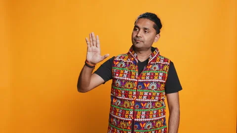 Person doing calm down sign gesturing, studio background Stock Footage 274851378