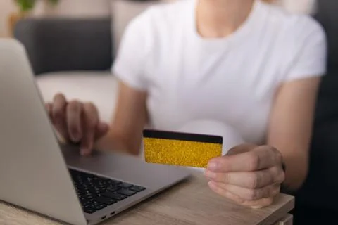 Person doing online shopping using laptop and holding credit card for secur.. Stock Photos