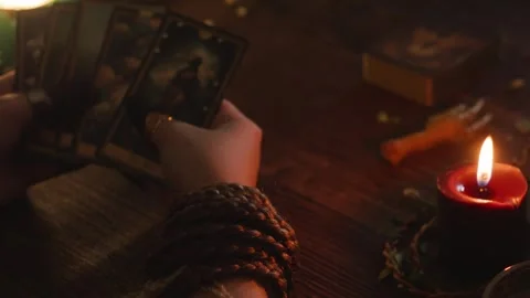 Person doing tarot reading, holding oracle cards, predicting future, using Stock Footage 318869878