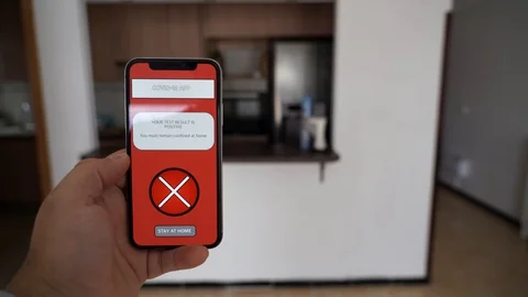 A person doing a thumbs down holding a smartphone that swhows a coronavirus a Video stock 129043011