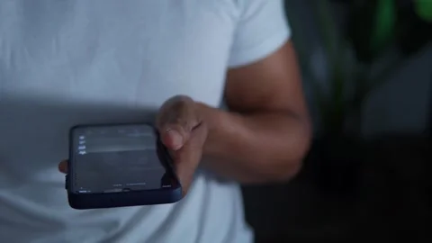 Person doom scrolling on a smartphone late at night Stock Footage 344756718