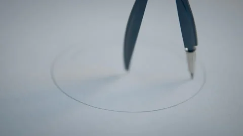 Person drawing a circle with a pencil compass on a piece of paper Stock Footage 274584871