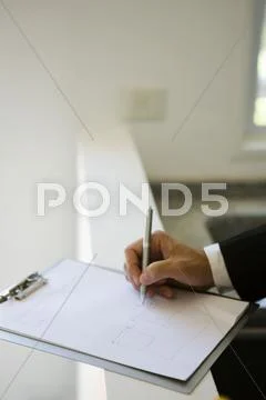 Person drawing on clipboard pad Stock Photos