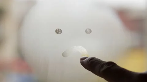 A Person Drawing a Sad Face on a Window Glass Stock Footage 234425038