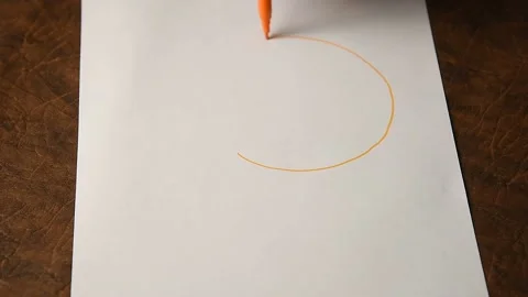 A person draws bitcoin on paper. Stock Footage 145091176