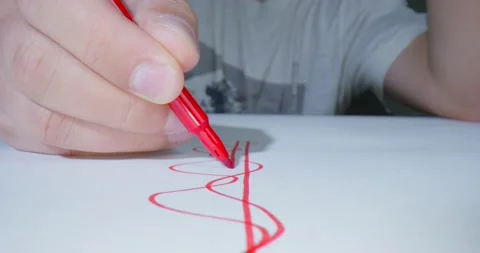 Person draws graph line or pattern for new project design with a red felt-tip Stock Footage 165572942