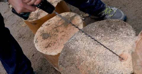 Person drilling stepping stump Stock Footage 116861004