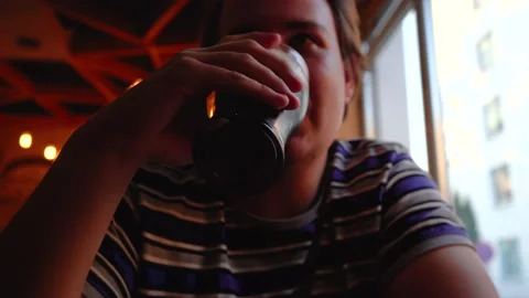 Person drinks beer sitting at a table Video stock 137274960