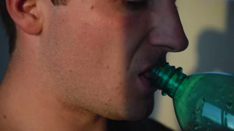 Person drinks water from a bottle. close up Video stock 136814751