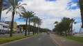 Person driving in busy street near ocean beach, urban life in resort town 4k or 4k+ Resolution