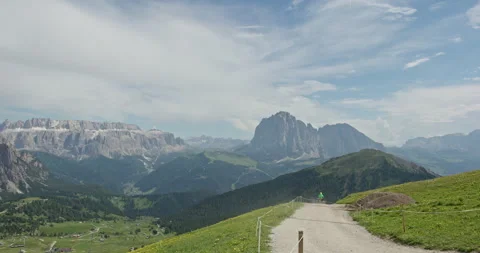Person driving a fun bob on a rail with a panoramic view of the dolomites Stockbeeldmateriaal 340780916