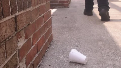 Person Drops Empty White Cup on Sidewalk and Walks Away Stock-Footage 347588143