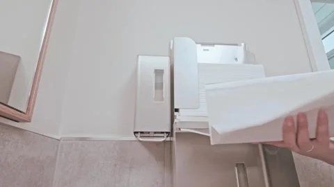 Person Drying Hands and Discarding Paper Towel Stock Footage 345650558
