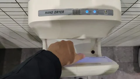 Person drying wet hands using modern electric hand dryer Vídeo Stock 340326712