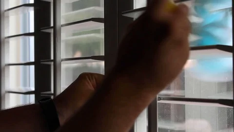 Person Dusting the Window Shutters Video stock 116129856