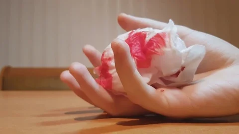 Person dying, hand falling on table with blood on tissue, life leaving the body Stock Footage 82181817