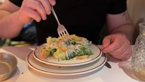 Person eating fresh caesar salad Stock-Footage 336458574