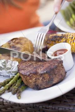 Person eating grilled beef steak Stock Photos