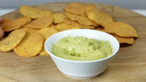 Person eating guacamole while scooping a chip Stock-Footage 126936820