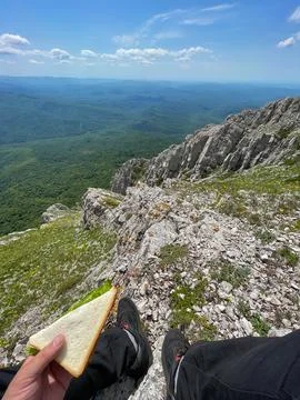 A person eats bread on a trip hiking nature mountains Stock Photos