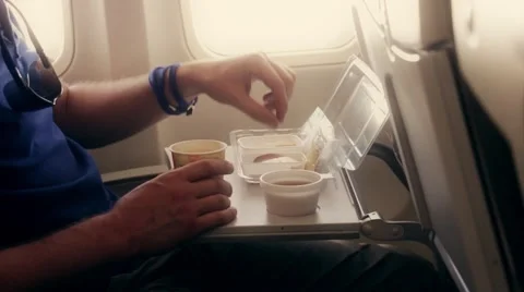 The person eats a breakfast in the old plane economy class Stock Footage 56228057