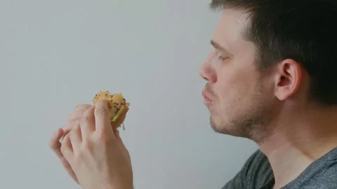 A person eats a burger Stock-Footage 244709490