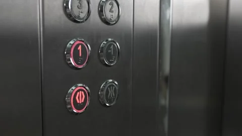A person in elevator presses button with number one to go to first floor Stock Footage 213664082