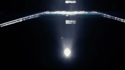 Person emerging from a pool of water under lights outdoors Stock Footage 275263025