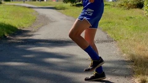 A person energetically jumping rope on a path in athletic gear Stock Footage 318924970