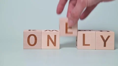 A person engages in a hands-on activity using wooden blocks to change words from 库存影片 338187604
