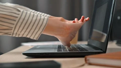 A person engages in typing on a laptop while performing various wrist and hand Stock Footage 339005509