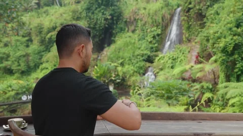 Person Enjoy Coffee While Admiring Beautiful Waterfall Lush Tropical Forest Bali 動画素材 344833964