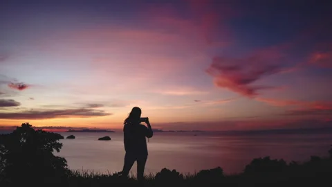 Person enjoy dramatic beautiful ocean sunset sky Stock Footage 261172935