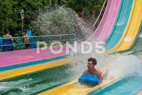 Person enjoying amazing splashing in Tamauta Racer attraction 4 Stock Photos