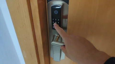 Person entering passcode on digital door lock Stock Footage 342348160