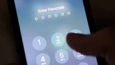 Person entering a passcode on an iPhone Video stock 270007968