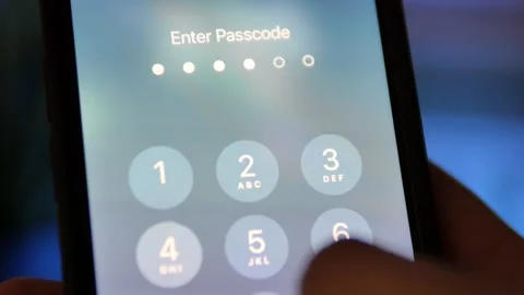 Person entering a passcode on an iPhone Video stock 270009463