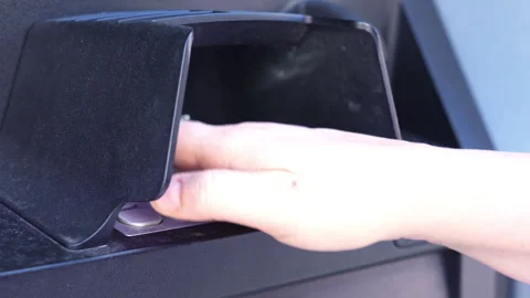 Person entering PIN code on ATM keypad under protective shield Stock Footage 347181273