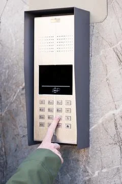 Person entering security code on keypad access control system. Stock Photos