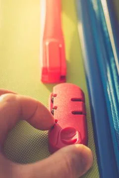 Person enters code on the locking mechanism on the suitcase Foto stock