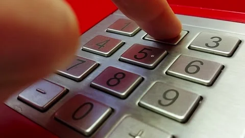 A person enters a pin code at an ATM. Finger presses ATM digit buttons. Concept Stock Footage 157750468