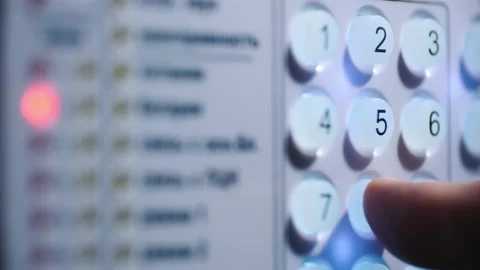 A person enters a pin code on a backlit keyboard Stock-Footage 130939319