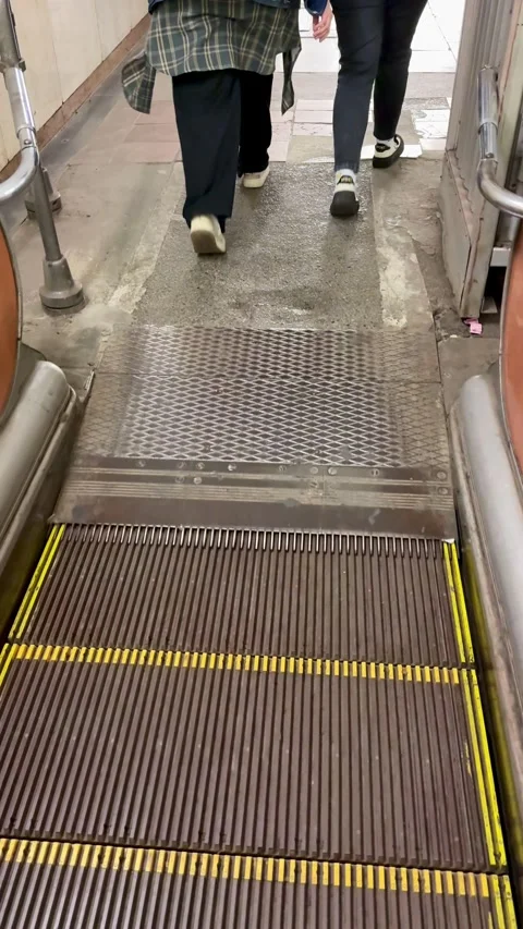 Person on escalator in transit environment, Closeup of commuter on busy transit Stock Footage 325234554